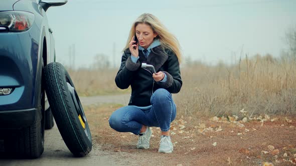 Woman Calling To Car Service. Waiting Tow-ruck Picking Up Broken Car.Driver Calling To Auto Mechanic