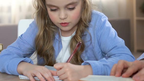 Proud Father Kissing Daughter Learning to Write, Parent Praise, Family Support