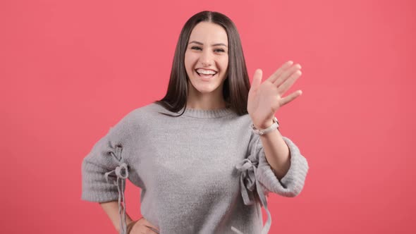 Friendly Beautiful Woman Saying Hi and Smiling, Welcoming Friends with Hand.