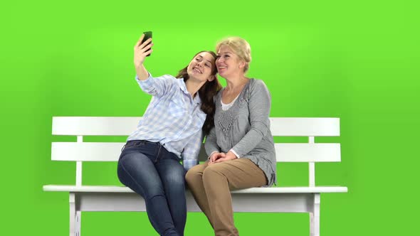 Mom and Daughter Do Selfie. Green Screen