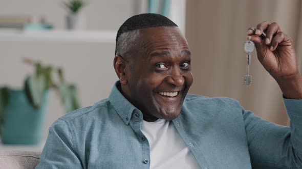 Closeup Happy Adult African American Man Sitting Looking at Camera Showing Bunch of Keys From New