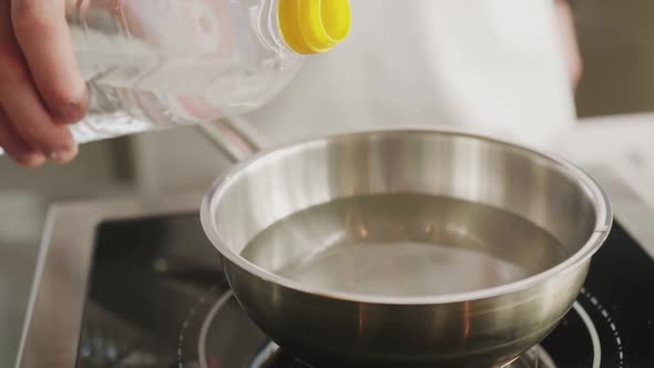 Closeup Cook Man Pours Vinegar Into Water