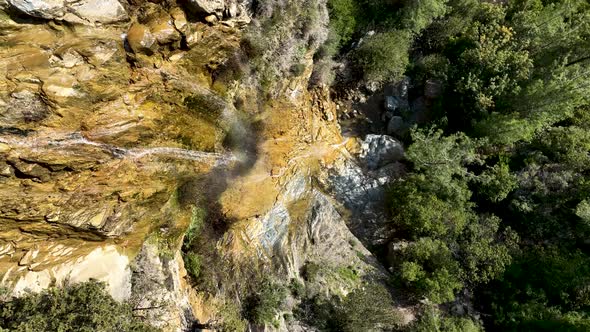 A small waterfall in the mountains aerial view 4 K