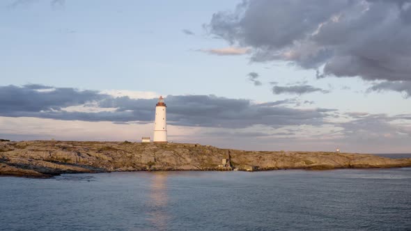 Aerial View Of Lille Torungen Lighthouse In Arendal, Norway On A Cloudy Day - drone shot