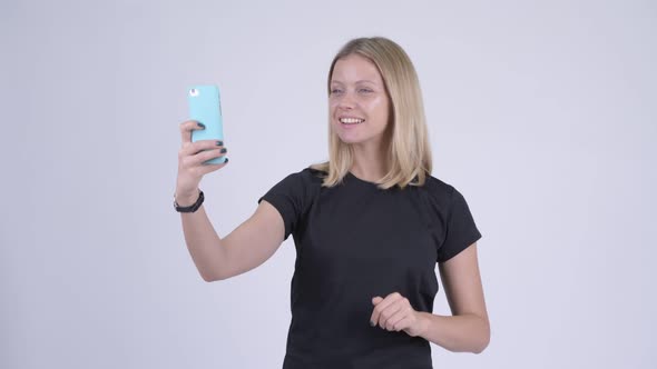 Young Happy Blonde Woman Video Calling with Phone