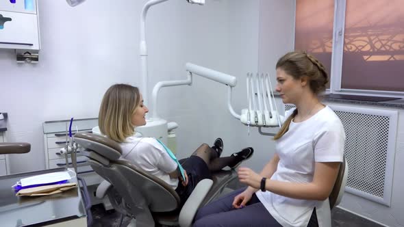 The Dentist and the Relaxed Patient are Talking About the Dental Issue