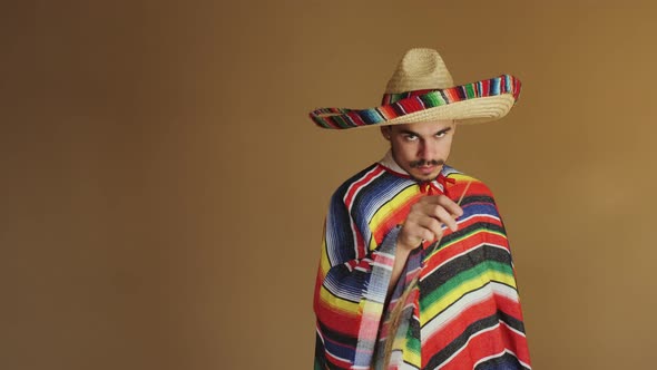 Young Mexican In Multicolored Poncho And Hat