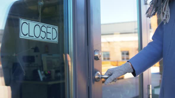 Woman in Glove Trying To Open Closed Office Door