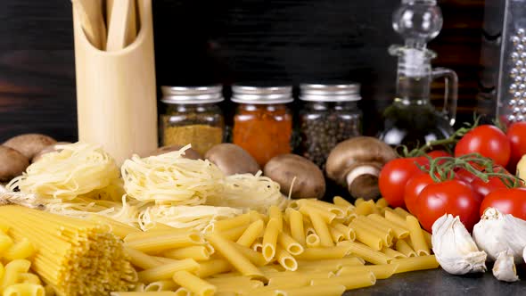 Uncooked Raw Variety of Pasta Next To Fresh Ingredients for Dinner