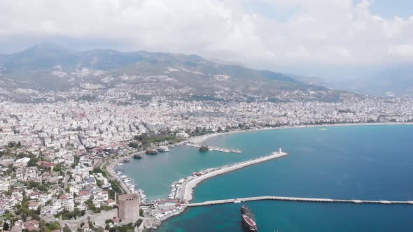 Aerial view landscape of Alanya through the arch of the old fortress. View of the city beach 