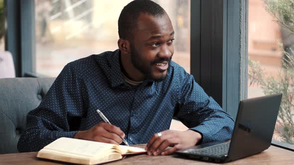 Businessman Working Remotely with Laptop at Cafe