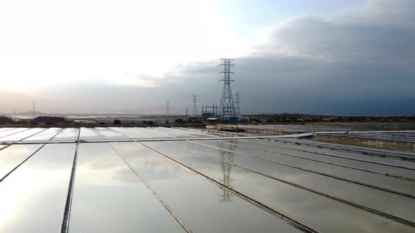 Aerial, industrial salt field reflecting sky from surface. Phan Rang, Vietnam