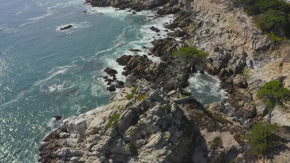 Slow Aerial Tilt Down Zoom in of the Rocky Shores of Big Sur Coast in California