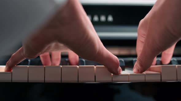 Close-up: a woman sensually plays the piano