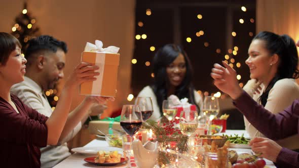 Friends Having Christmas Feast and Giving Presents