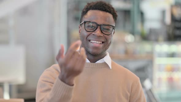 Creative African Man Pointing at the Camera and Inviting