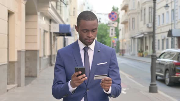 Walking African Businessman Shopping Online