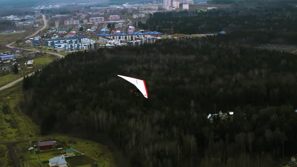 A Hang Glider Flying Over the Suburb