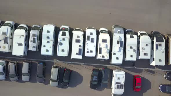 Aerial view of many camper vans on a parking lot.