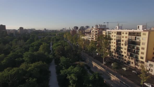 Street with park and traffic in Valencia, aerial view