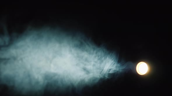 Studio Lighting Device with a Narrow Beam Illuminates Smoke in the Dark