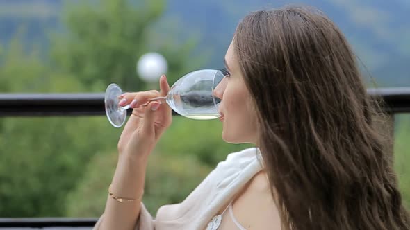 the Girl Drinks White Wine Sexy Young Woman with Glass of Wine