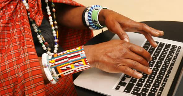 Tribal man using laptop 4k
