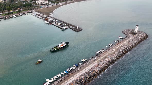 Ship tug sails out of port aerial view Turkey Alanya 4 K