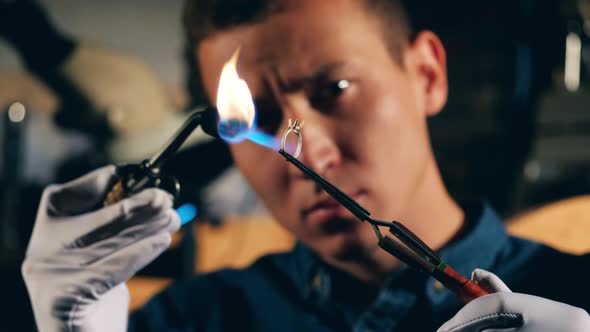 A Silversmith Is Burning a Ring with No Stones