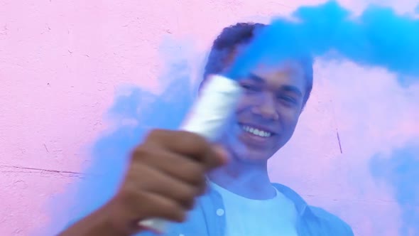 Afro-American Boy Waving Blue Smoke Bomb, Celebrating Life, Entertainment