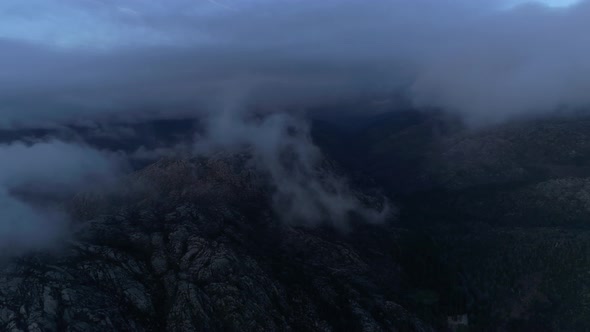 Fly Through the Clouds Over the Mountain Peaks