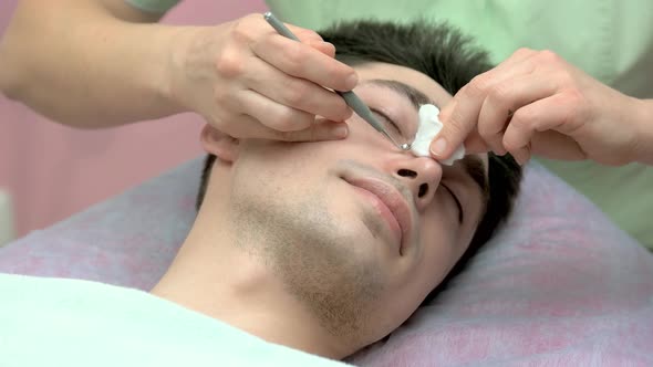 Cosmetician Cleaning Face Close Up