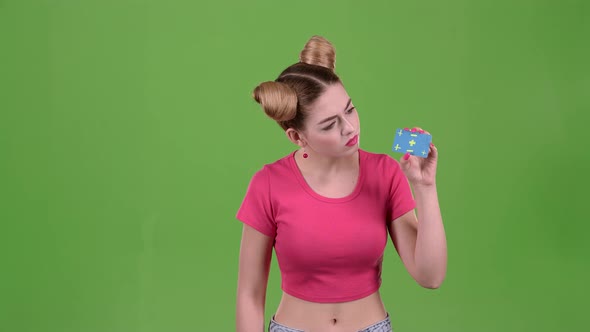 Teenager Advertises a Card and Shows a Finger Down. Green Screen. Slow Motion