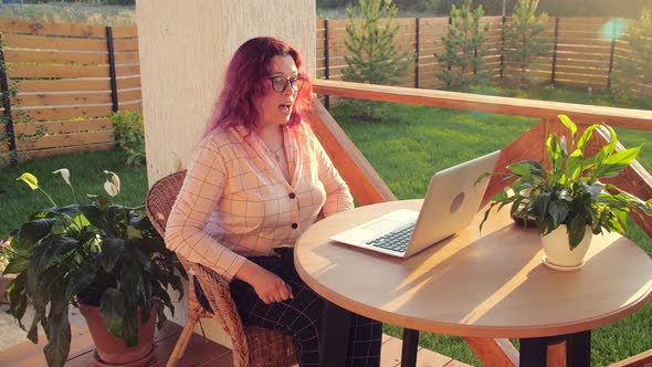 Woman Videoconferencing with Her Friend Via Online App on Laptop