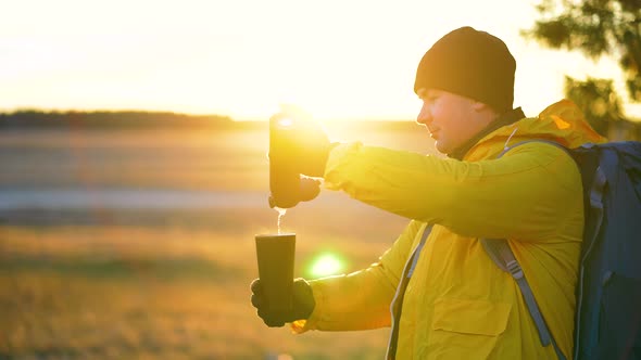 Hiker Young Tourist Enjoying Nature Drinking Hot Tea at Sunset