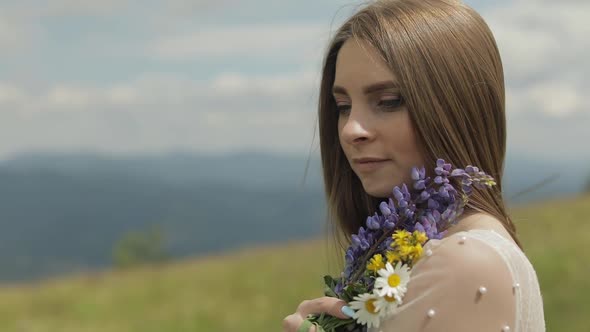 Close Up Shot of Brides Face. Bride in Wedding Dress Stay with Bouquet