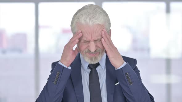 Old Businessman Having Headache