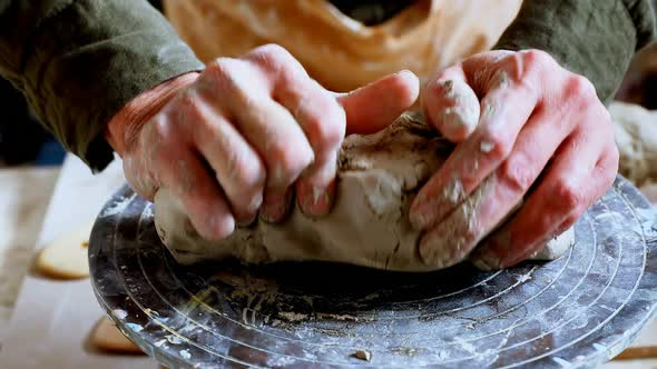 Male potter moulding a clay 4k