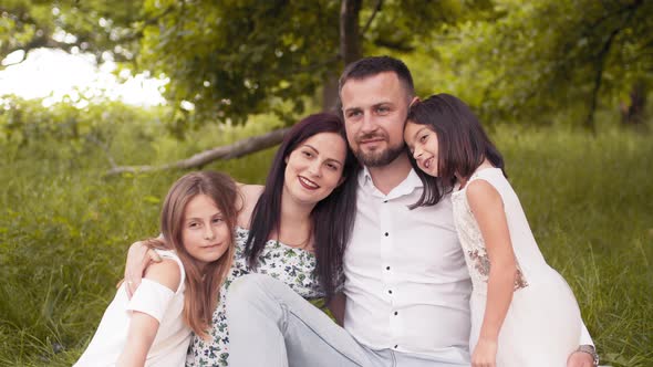 Beautiful Caucasian Family Enjoying Summer Picnic at Green Garden