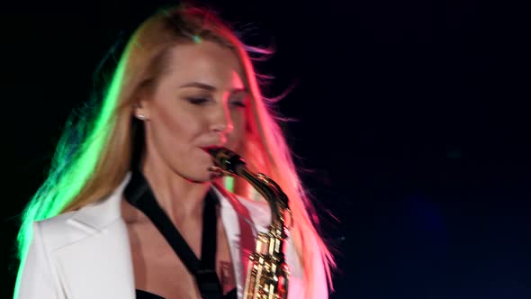 Young Sexy, Blonde Woman Dj in White Jacket and Black Top Playing Music Using Saxophone, Close Up