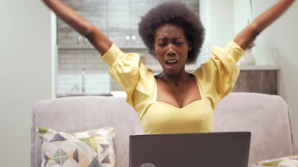 African American Woman is Relaxing After Work Freelancing at Home Indoor