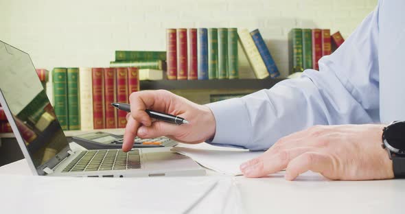 Male Hands in the Office Works with a Laptop Touchpad