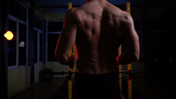 Young Bodybuilder Training in the Gym with Resistance Bands