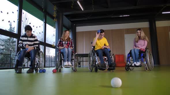 Disabled People in Wheelchairs Playing Boccia