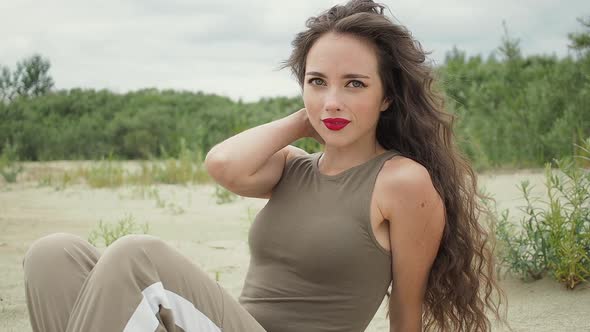 Pretty Woman Touching Hair on Beach