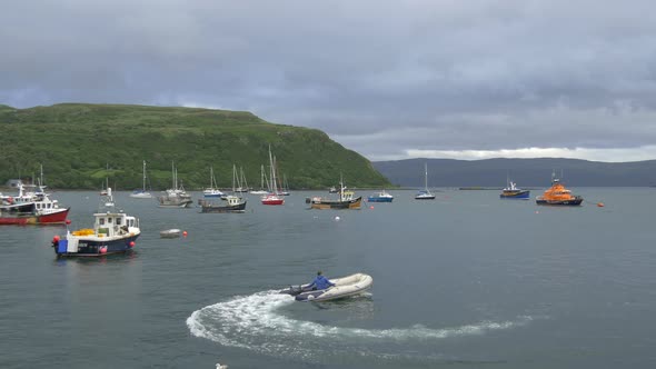 A man sailing a motorboat in a harbor