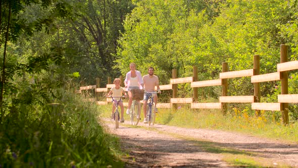 Happy Family Riding Bicycles in Summer Park