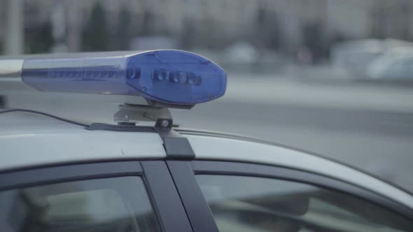 Flashing Flasher on the Roof of a Police Car. Blinker. Close-up.