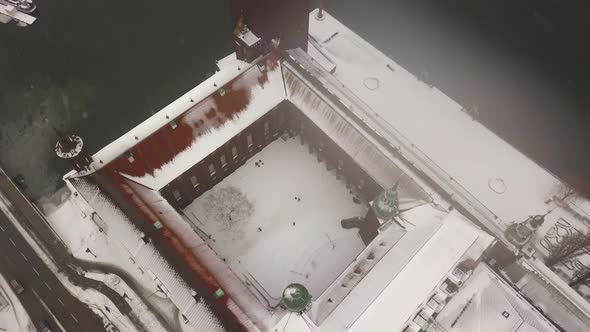 Birdseye view of iconic City hall in Stockholm with tiny tourists exploring around the historical la