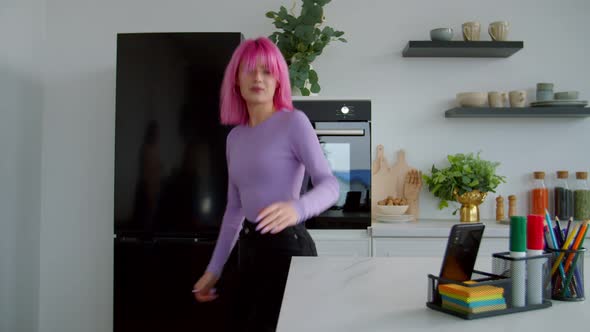 Carefree Trendy Lovely Pink Haired Female Recording Video on Cellphone at Home